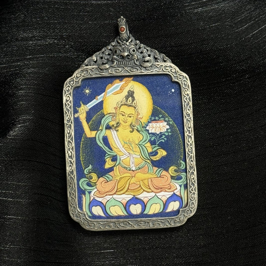 The Bold Manjushri Thangka pendant displayed as a sacred amulet for wisdom and success, embodying the wisdom of Tibetan Buddhist tradition.