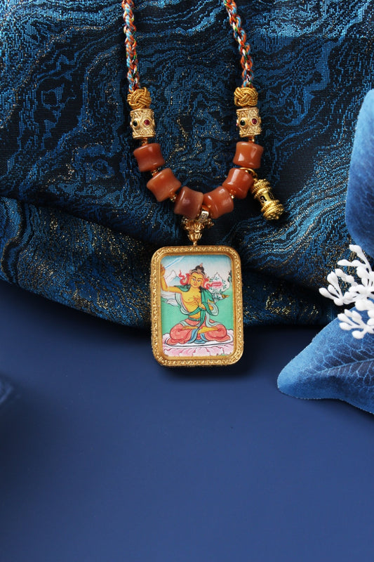 A 4x5cm hand-painted Karma Kagyu Manjushri Bodhisattva Thangka pendant featuring the Bodhisattva of Wisdom, encased in titanium steel, representing wisdom and clarity in Tibetan Buddhist tradition.