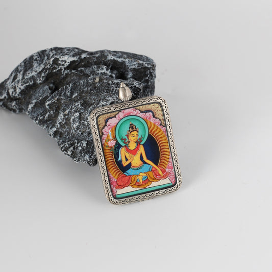 The Karma Kagyu Manjushri Thangka pendant displayed as a sacred amulet for wisdom and learning, embodying the sword of wisdom of Tibetan Buddhist tradition.