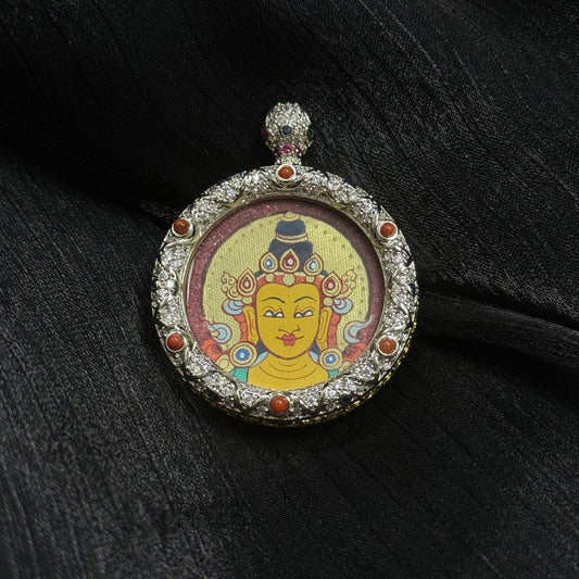 The Rekong Red-Gold Manjushri Buddha Head Thangka pendant displayed as a sacred amulet for wisdom and blessing, embodying Buddhist tradition.