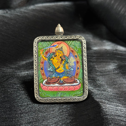 Detailed view of the presentation and casing for the Manjushri Cuiying Thangka pendant, symbolising wisdom and tradition in Buddhist practice.