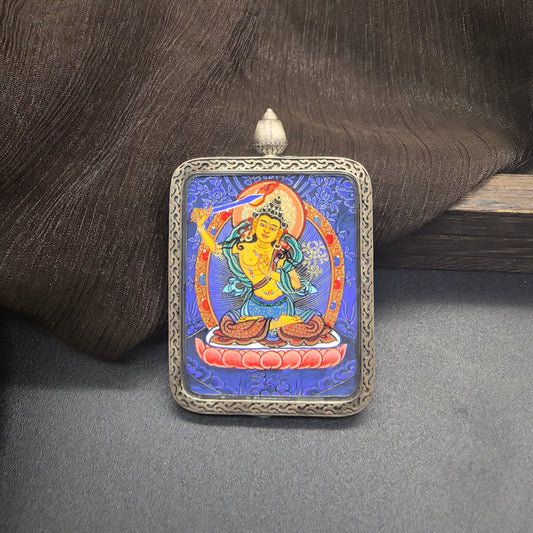 Close-up detail of the Rekong Blue Thangka Manjushri painting showing natural mineral pigments, showcasing the masterful artistry of Rekong lama painters.
