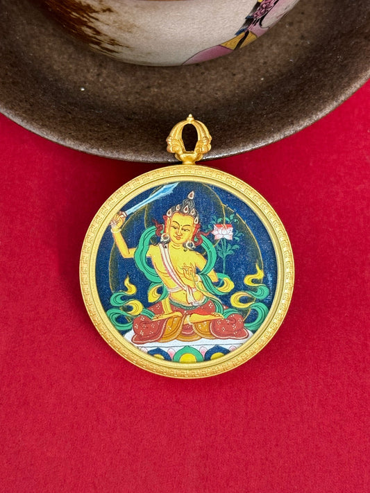 Close-up detail of the Tibet Bold Manjushri Thangka showing hand-painted mineral pigments, gold and lapis, showcasing the masterful artistry and three-dimensional imagery.