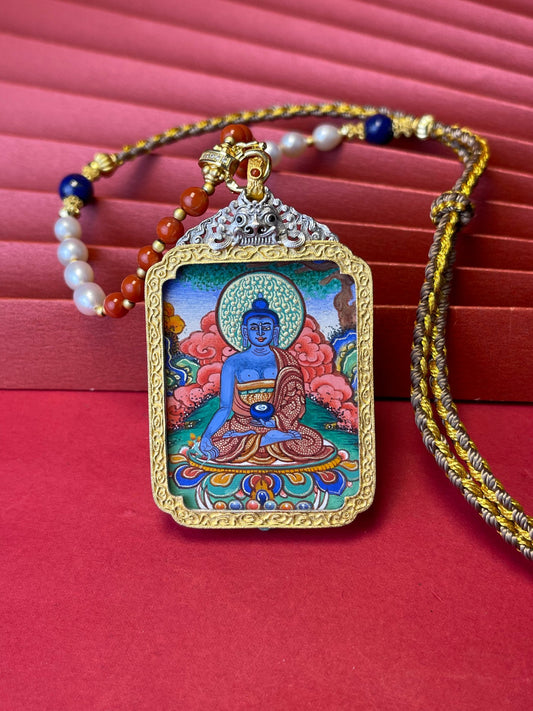 Hand-painted Rekong Medicine Buddha (药师佛) Thangka pendant 3.5x4.5cm with 925 silver casing featuring healing and pacify illness, representing fulfil wishes in Buddhist tradition.