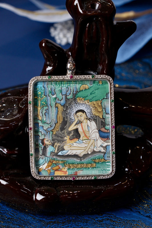 Tibetan Buddhist thangka pendant depicting Milarepa, the enlightened Tibetan yogi and master, symbolizing spiritual awakening and inner freedom.