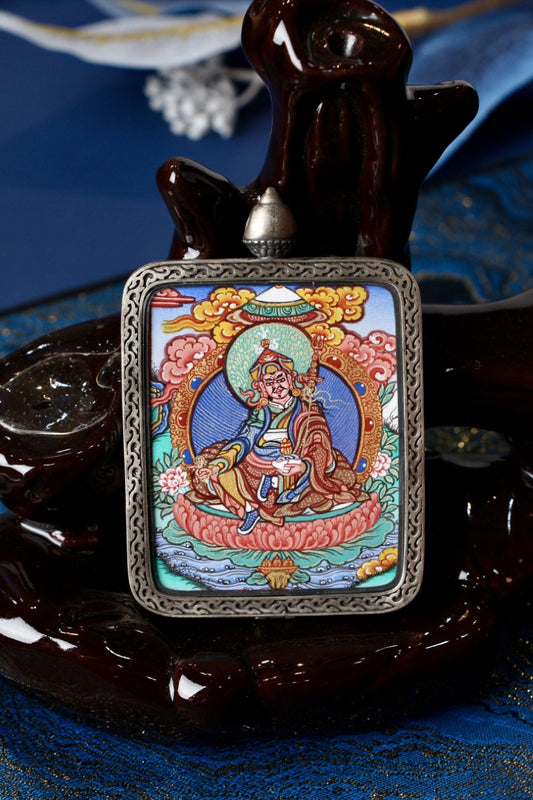 Guru Rinpoche lotus seat thangka amulet pendant, symbolizing purity, realization, and spiritual guidance in Tibetan Buddhism