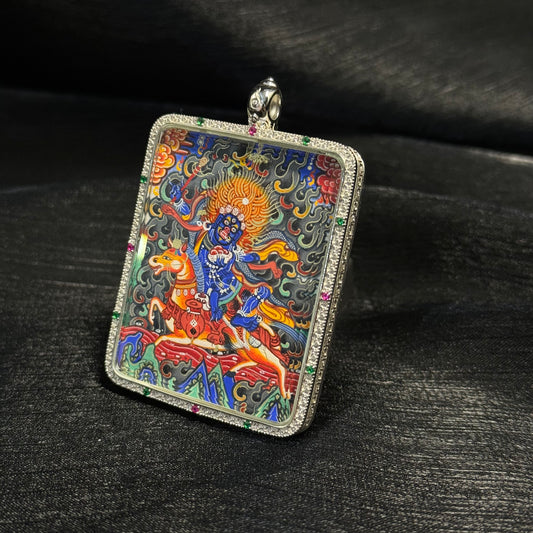 A 4x5cm hand-painted Rekong Palden Lhamo (Shri Devi) Thangka pendant, representing fulfilment of wishes, longevity, wealth and auspiciousness in Buddhist tradition.