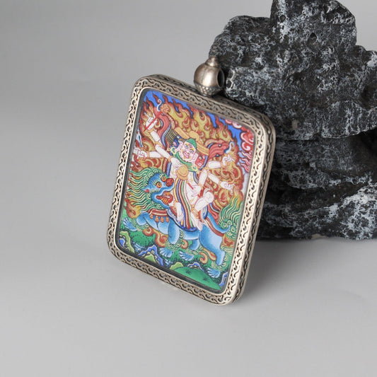 The Rebgong Pehar Thangka pendant displayed as a sacred amulet for protection and success, embodying Tibetan Buddhist tradition.