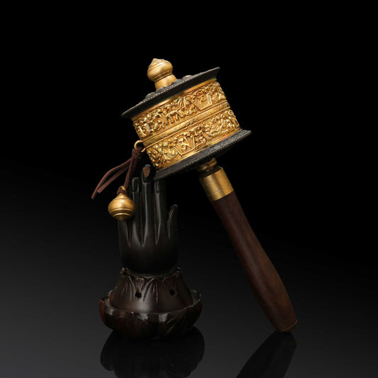 Close-up of a traditional Tibetan Buddhist Mani wheel showing intricate carvings and mantras