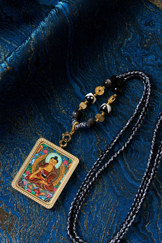 Tibetan thangka jewelry featuring Shakyamuni Buddha, inspired by classical Tibetan Buddhist iconography.