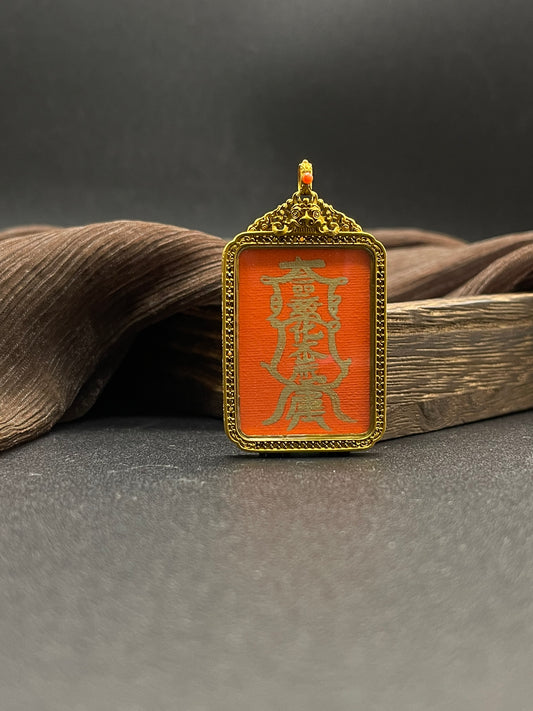 Close-up detail of the Rekong Tai Sui Talisman showing cinnabar base and pure gold pigment, showcasing the masterful artistry.