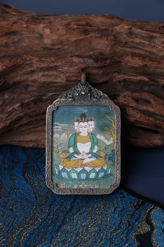 Tibetan thangka amulet featuring Vairocana Buddha, representing universal light and the essence of Dharma in Tibetan Buddhism.