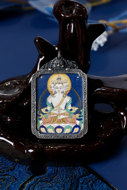Vairocana Buddha thangka amulet used in Tibetan Buddhism for spiritual clarity, balance, and protection.