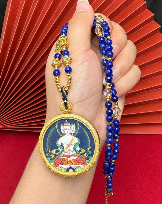 The Tibet Bold Vairocana Thangka pendant with copper casing displayed as a sacred amulet for wisdom and the accomplishment of endeavours, embodying Buddhist tradition.