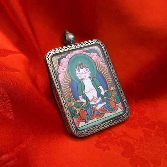 A 3.5x4.5cm hand-painted Tibet Red Cloud Vairocana (大日如来) Thangka pendant with 925 silver featuring the Buddha of luminous wisdom, representing light and success in Buddhist tradition.