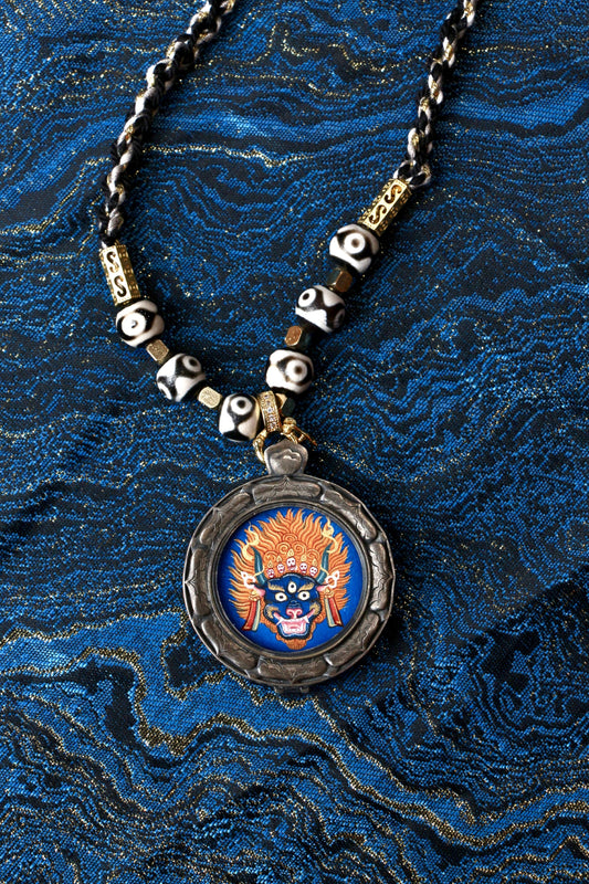 Close-up detail of the Tibetan Buddhist Vajrabhairava Thangka painting showing intricate natural mineral pigment work, three all-seeing eyes, and gold-accented skull crown, showcasing the masterful artistry of Tibetan lineage painters.