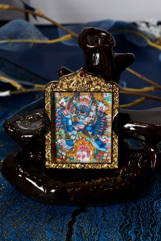 Yamantaka thangka pendant depicting a wrathful deity in Tibetan Buddhist culture, symbolizing the conquest of death and ignorance.