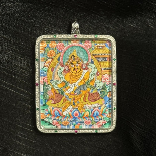 The Yellow Jambhala with Mandala Thangka pendant displayed as a sacred amulet for right wealth and career, embodying Tibetan Buddhist tradition.