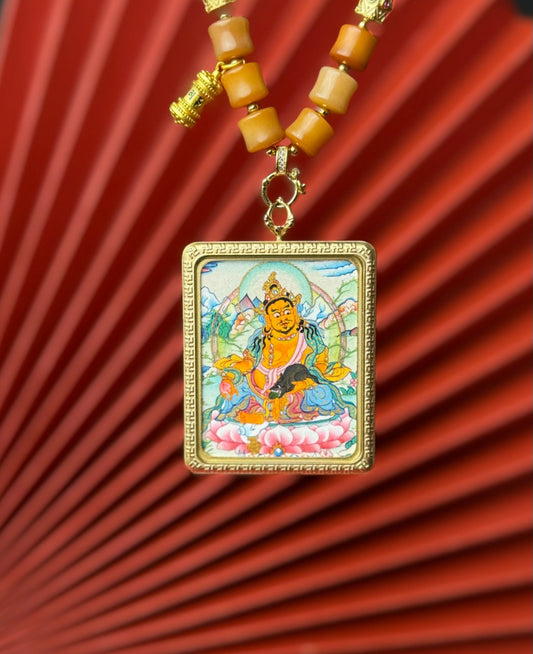 Detailed view of the titanium casing for the Yellow Jambhala Thangka pendant, symbolising wealth and tradition in Buddhist practice.