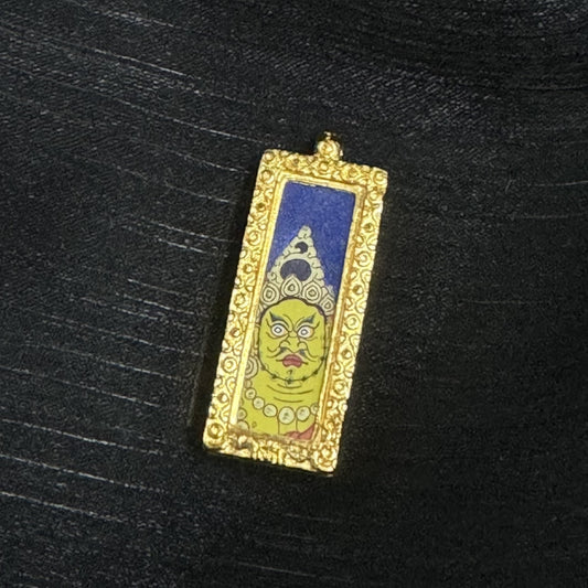 Hand-painted Rebgong Buddha Head Yellow Jambhala Thangka pendant featuring the King of Wealth, encased in copper, representing prosperity and Dharma in Tibetan Buddhist tradition.