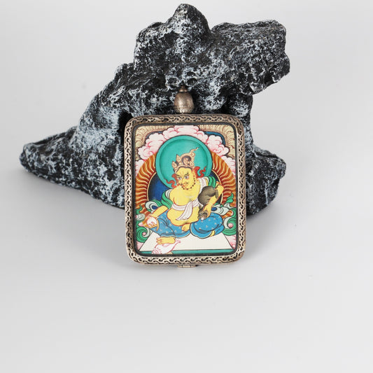 Close-up detail of the Rebgong Yellow Jambhala Thangka painting showing intricate natural mineral pigment work and jewel symbolism, showcasing the masterful artistry of Tibetan lineage painters.