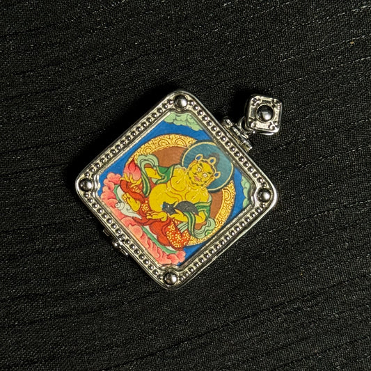 Close-up detail of the Rekong Yellow Jambhala Thangka painting showing natural mineral pigments, showcasing the masterful artistry of Rekong lama artists.