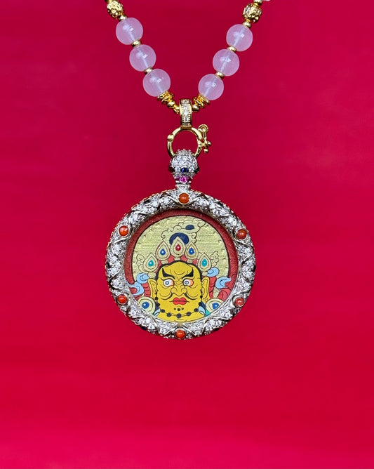 Close-up detail of the Rekong Red Gold Yellow Jambhala Thangka showing hand-painted mineral pigments, cinnabar and gold, showcasing the masterful artistry and rich texture.