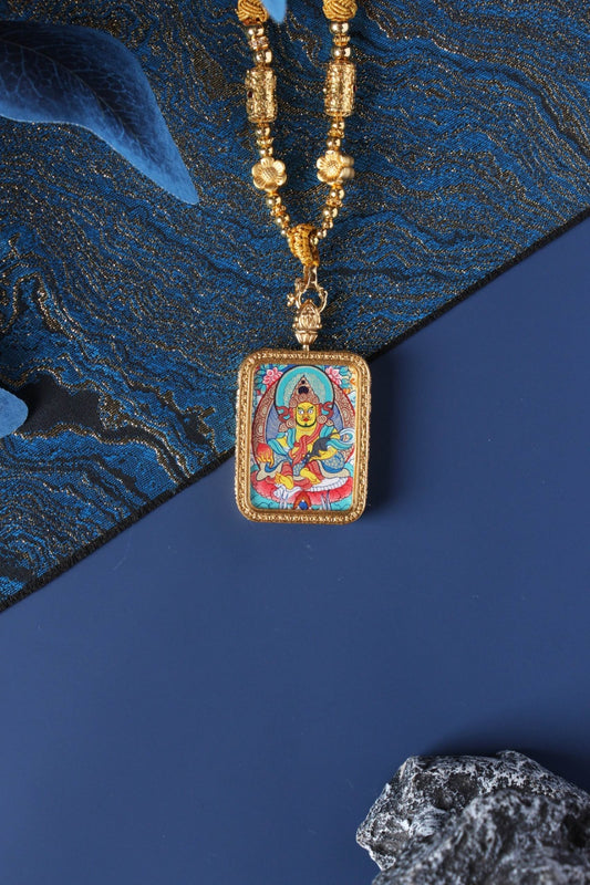 Close-up detail of the Tibetan Buddhist Yellow Jambhala Thangka painting showing intricate natural mineral pigment work and gold-accented ornaments, showcasing the masterful artistry of Tibetan lineage painters.