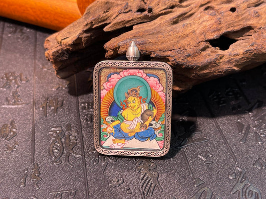 Close-up detail of the Tibet Yellow Jambhala Thangka showing hand-painted mineral pigments, showcasing the masterful artistry and colour stable for a thousand years.