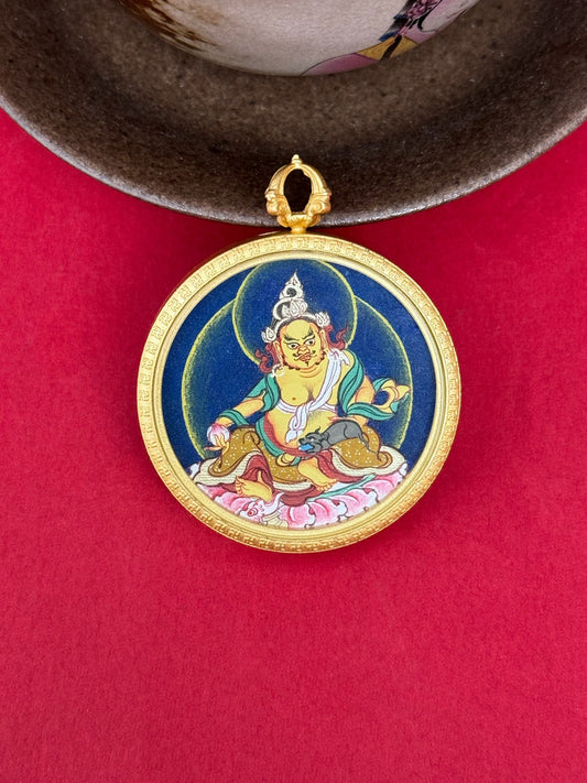 Close-up detail of the Tibet Bold Yellow Jambhala Thangka showing hand-painted mineral pigments, gold and lapis, showcasing the masterful artistry and three-dimensional imagery.