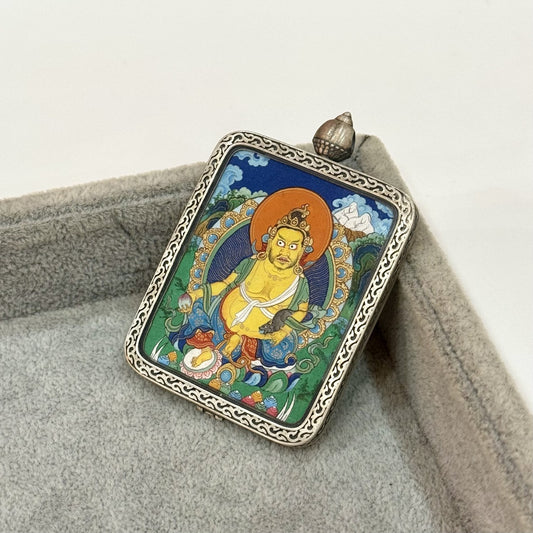Hand-painted Tibet Miansa Yellow Jambhala Thangka pendant featuring the King of Wealth, encased in Dunhuang Nine-Color Deer silver case, representing prosperity and merit in Tibetan Buddhist tradition.