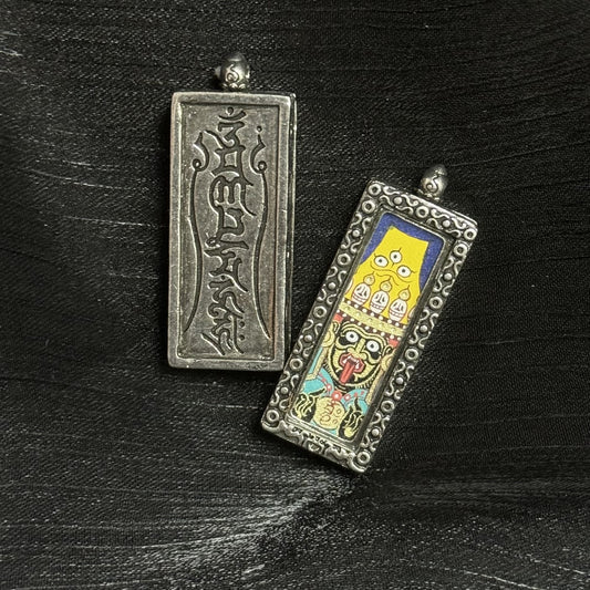 Hand-painted Rebgong Buddha Head Zhagilamu Thangka pendant featuring the Tibetan female wealth deity, encased in copper, representing fortune and wishes fulfilled in Tibetan Buddhist tradition.