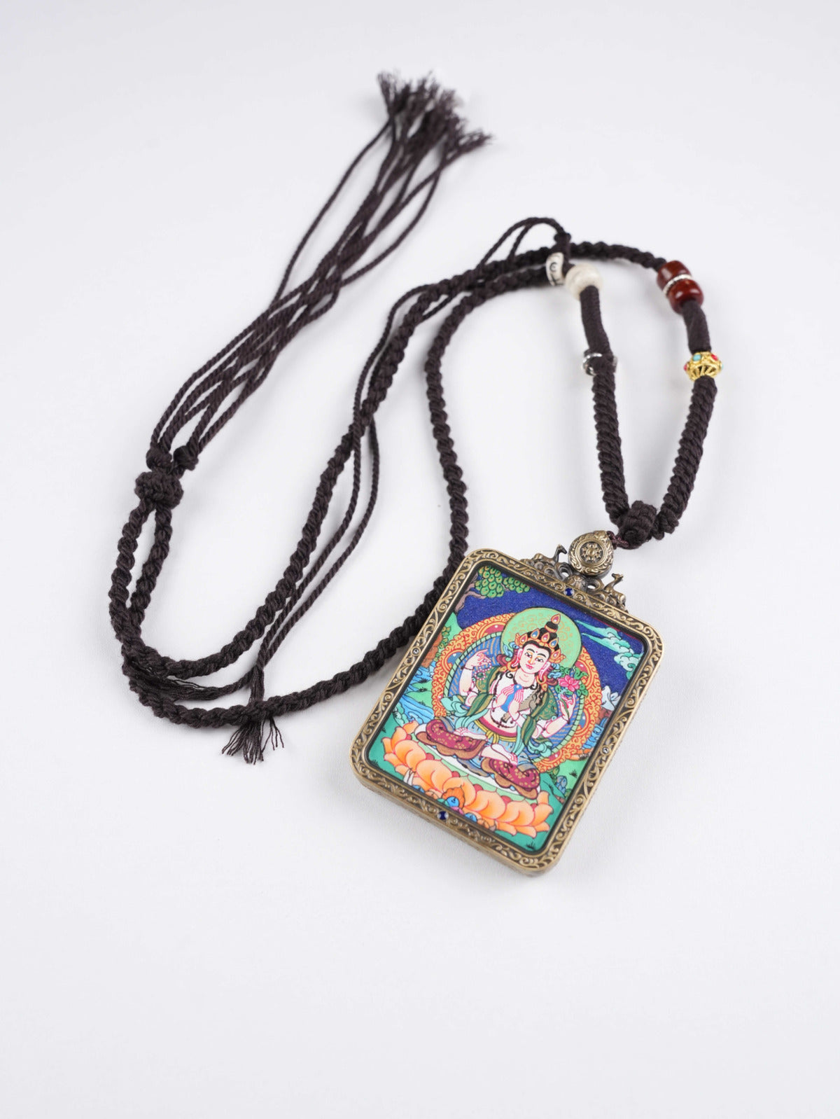Mini Tibetan thangka pendant of Four-Armed Avalokiteshvara, zodiac protector amulet symbolizing love, harmony, and enlightenment in sacred Buddhist art.