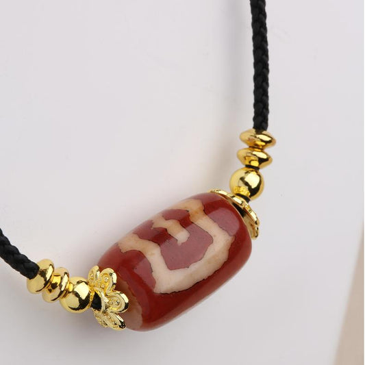 Tibetan Buddhist red Garuda agate pendant necklace inspired by traditional thangka painting, handcrafted with copper alloy and glass details symbolizing protection and power.