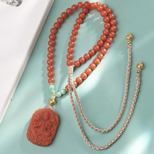 Tibetan Buddhist handcrafted Tara necklace made of red agate and jade, symbolizing protection and compassion.