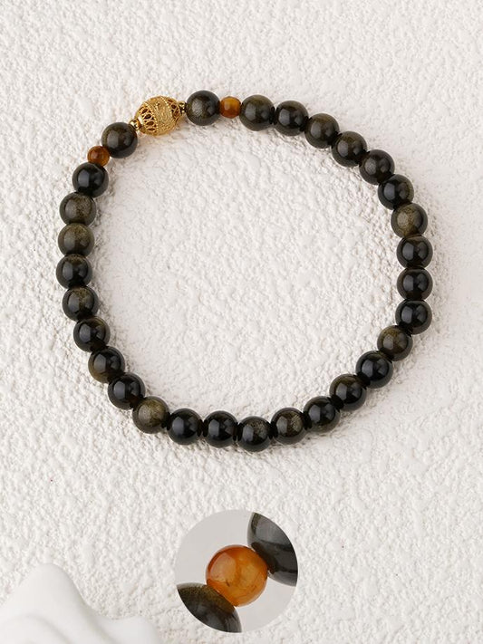 Tibetan-Buddhist Golden Obsidian Yeminghui bracelet featuring white crystal and silver wisdom-eye charm