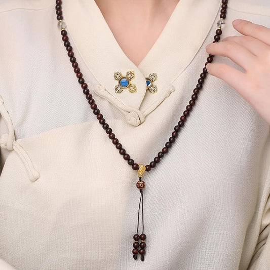 Tibetan Buddhist 108 mala necklace featuring green phantom crystals and sandalwood beads in handcrafted style