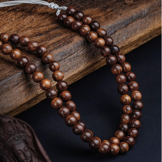 Handcrafted Tibetan Buddhist Avalokiteshvara necklace made of red sandalwood and silver.