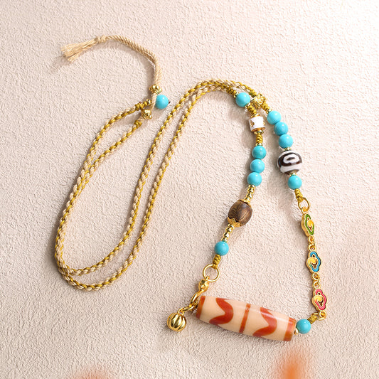 Handcrafted Tibetan Buddhist double tiger tooth Dzi pendant necklace for good fortune.