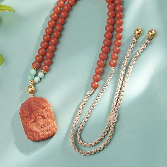 Hand-carved Tara pendant with red agate and jade beads, Tibetan Buddhist jewelry art design.