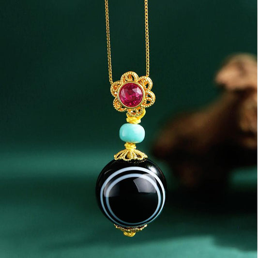 Tibetan Buddhist agate and turquoise pendant with 18K gold floral zircon mount, symbolizing harmony.