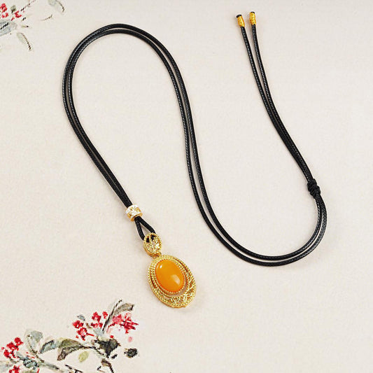 Tibetan Buddhist mala beads necklace with honey amber thangka pendant, crafted with alloy and copper for a unique spiritual accessory.