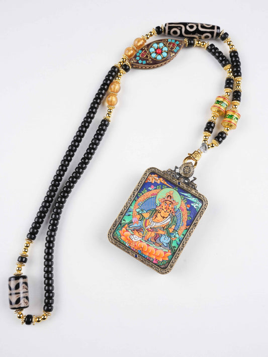 Hand-painted Tibetan Yellow Jambhala Thangka pendant representing the Buddhist Wealth Deity for abundance and prosperity.
