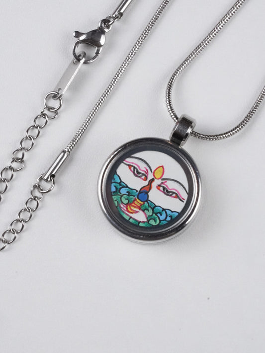 Mini thangka White Tara pendant necklace in Tibetan Buddha style, hand-painted on thangka canvas using mineral pigments, authentic Buddha art jewelry.