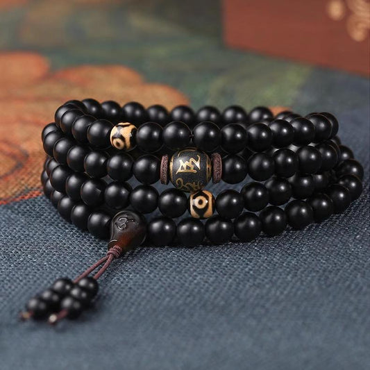 Handcrafted Tibetan Buddhist obsidian 108 beads mala necklace with black three-way connector and pendant.