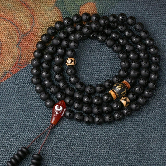 Handmade Tibetan Buddhist obsidian mala necklace featuring 108 beads and mantra bead.