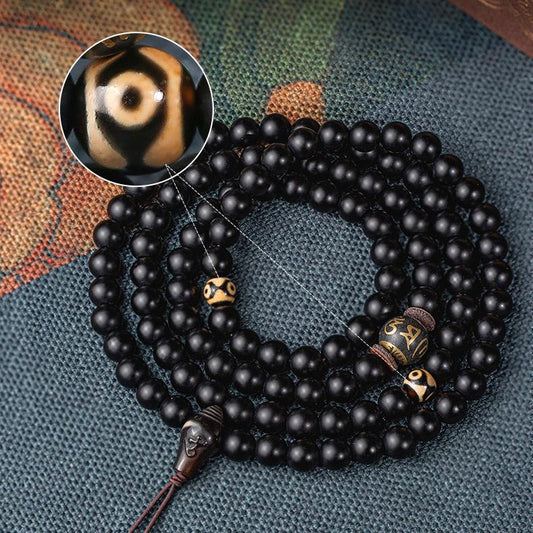 Tibetan Buddhist handmade obsidian mala featuring 108 beads, three-eye dzi bead, and agate three-way connector.