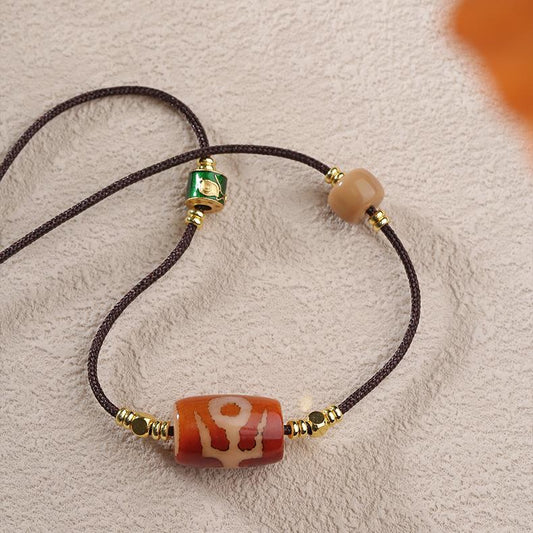 Tibetan Buddhist Red Nobleman Agate and Glass Pendant on an adjustable cord.