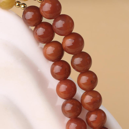 Alt text: "Tibetan Buddhist Thangka painting necklace with honey amber beeswax, representing purity and enlightenment. A unique piece inspired by traditional Tibetan art."