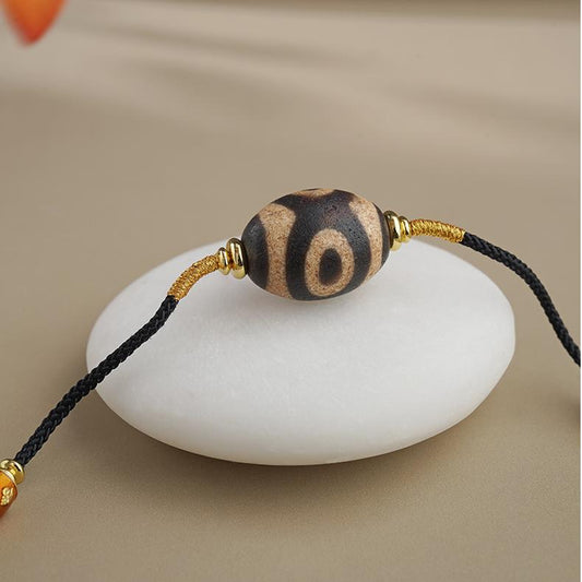 Tibetan Buddhist three-eye agate necklace inspired by thangka painting, handcrafted spiritual jewelry symbolizing wisdom and protection.